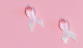 Two pink ribbons positioned in the centre-right region of the image.