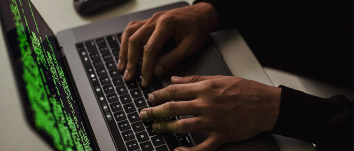 two hands typing on a laptop computer.